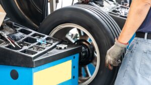 tech using automated wheel balancer