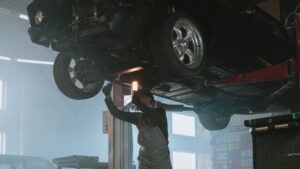 car mechanic under car