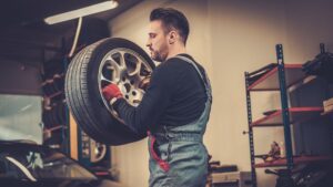 technician putting a balanced tire on a car
