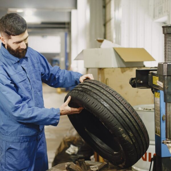 auto technician changing a tire