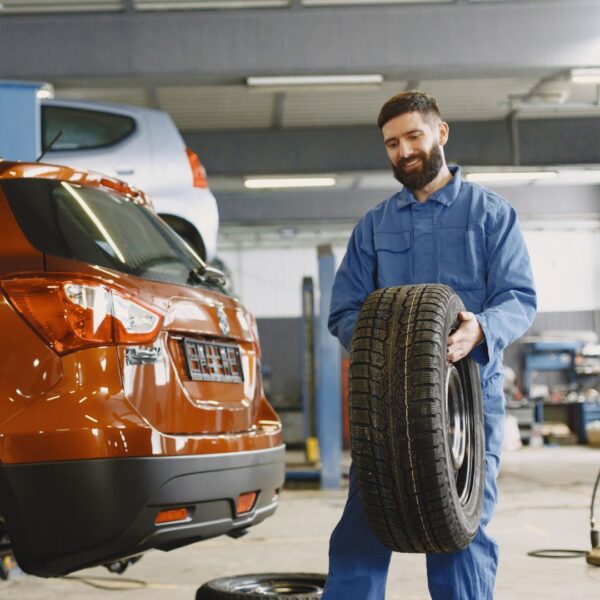 a man carrying a tire