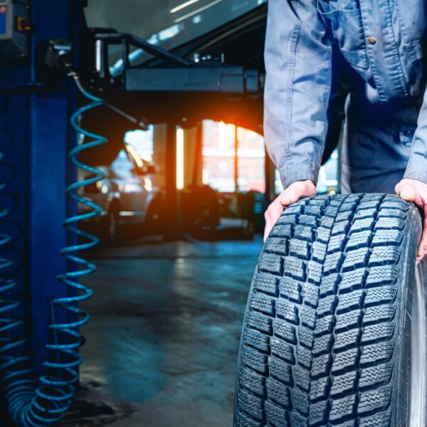 mechanic rolling out a tire